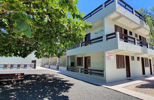 Itapoa Apartment | Apartment in a gated community with a swimming pool.