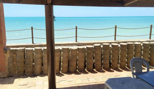 A private chale less than 20 feet from the ocean