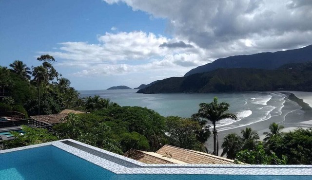 A retreat with 2 suites, an infinity pool, and a hot tub with a view.
