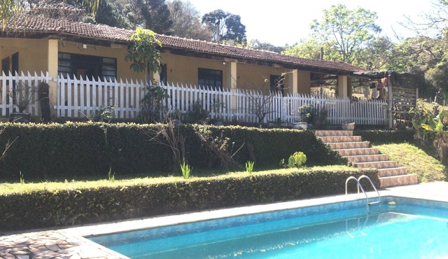 Beautiful property with a lovely house facing the lake, featuring an orchard, vegetable garden, and animals.