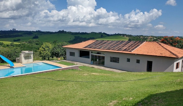 Huge farm with pool, game room and lots of green.