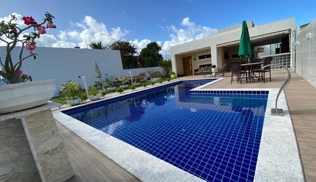 Modern 4-bedroom house with pool and barbecue area.