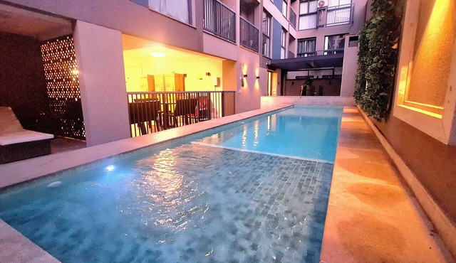Modern apartment with its own small backyard and swimming pool