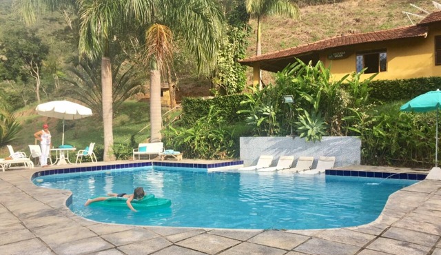 Private waterfall in the garden, swimming pool with small beach and stream with natural pool