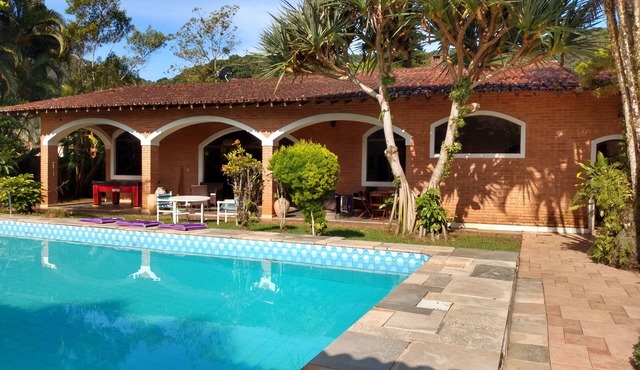Single-story house with pool in a gated community.